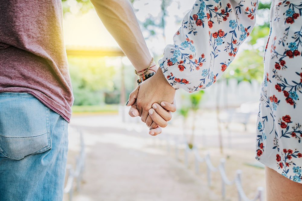 Close Up Of Couple Holding Hands Outdoors